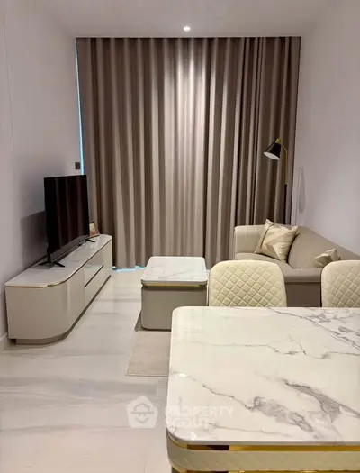 Modern living room with elegant marble dining table and cozy seating area, perfect for stylish urban living.