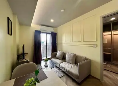 Modern living room with cozy sofa and balcony view in stylish apartment