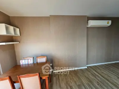 Cozy dining area with modern air conditioning, wooden flooring, and elegant wall textures, perfect for intimate family meals.