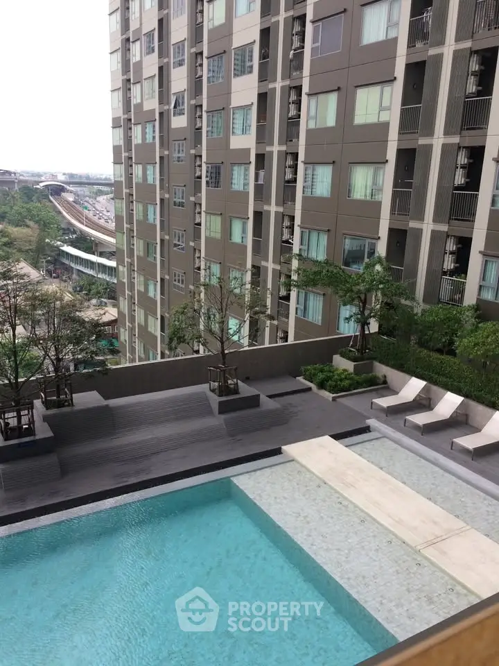 Modern apartment building with a luxurious pool and urban view, perfect for city living.