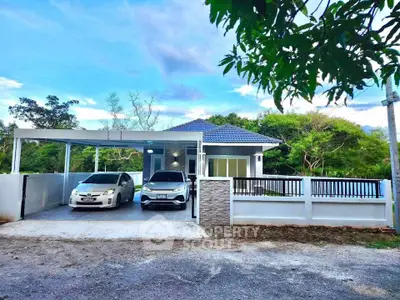 Charming modern house with carport and lush greenery, perfect for serene living.