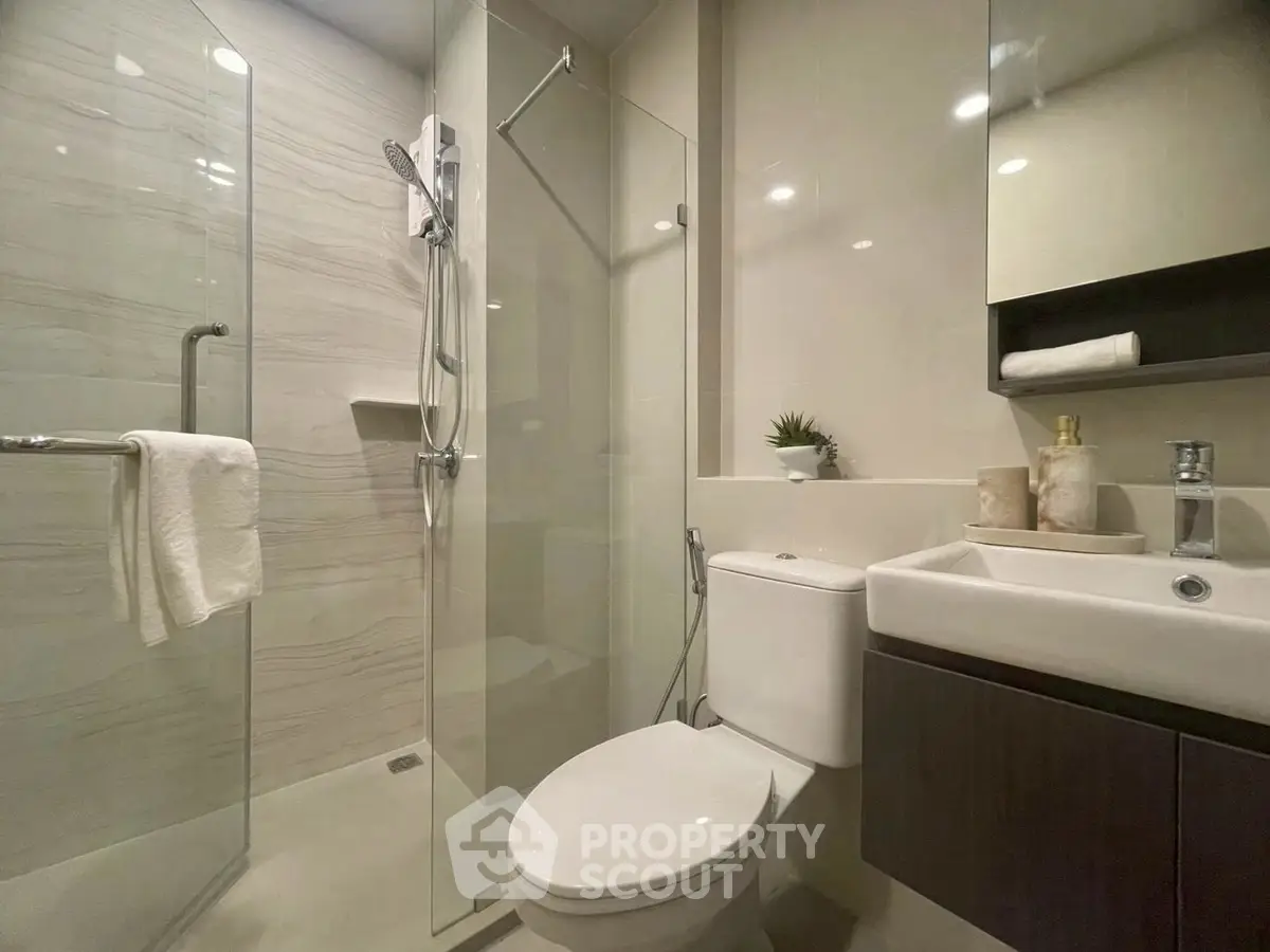 Modern bathroom with glass shower and sleek fixtures