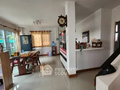 Spacious open-plan living and dining area with natural light and modern decor.