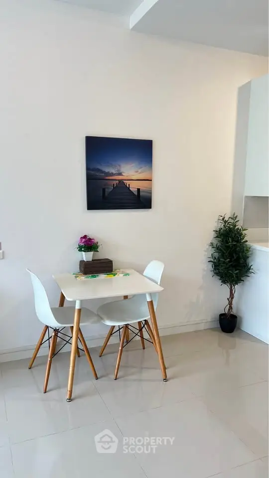 Modern dining area with stylish white chairs and table, minimalist decor