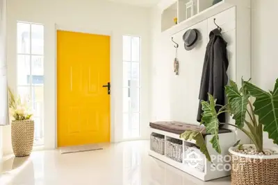 Bright entryway with yellow door and stylish storage solutions in modern home.