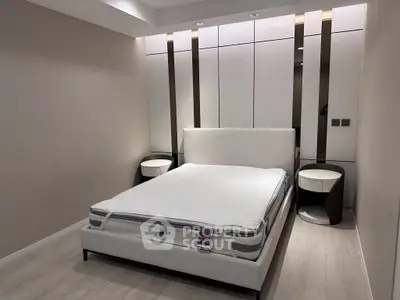Modern bedroom with sleek design and elegant furnishings, featuring a comfortable bed and stylish nightstands.