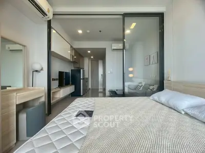Modern bedroom with sleek design and glass partition, featuring air conditioning and stylish decor.