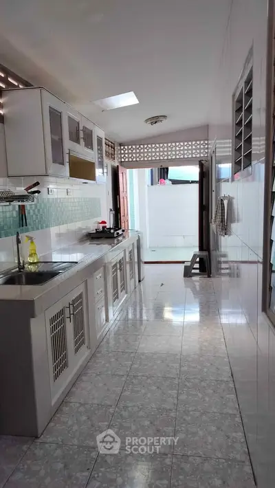 Spacious kitchen with closed layout and ample natural light