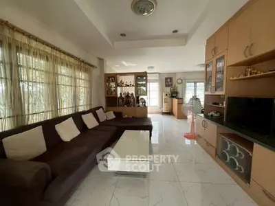 Spacious living room with modern decor and ample natural light