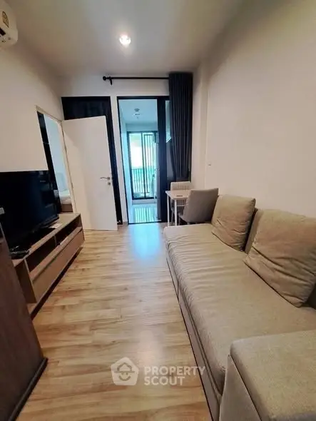 Cozy living room with modern decor and balcony access