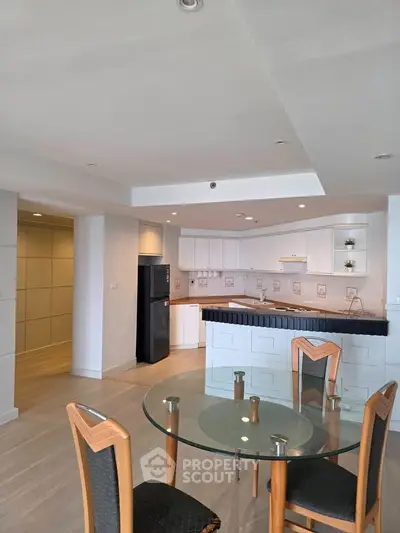 Spacious modern kitchen with open layout and dining area in a bright apartment.