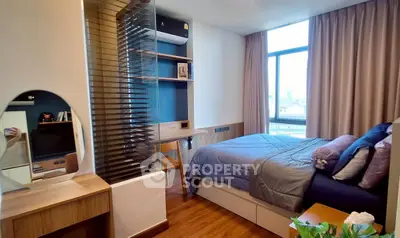 Modern bedroom with stylish decor and large window offering city views.