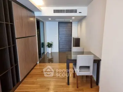 Modern apartment interior with wooden flooring and sleek furniture