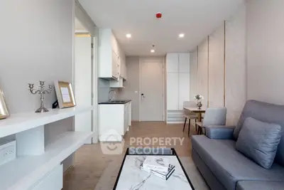 Modern living room with open kitchen and stylish decor in a contemporary apartment.
