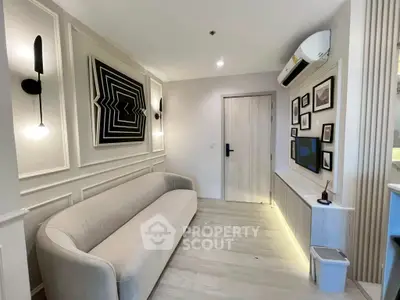 Modern living room with stylish decor and wall art, featuring a cozy sofa and ambient lighting.