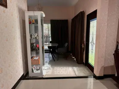 Charming entryway with glass cabinet and elegant decor in cozy home