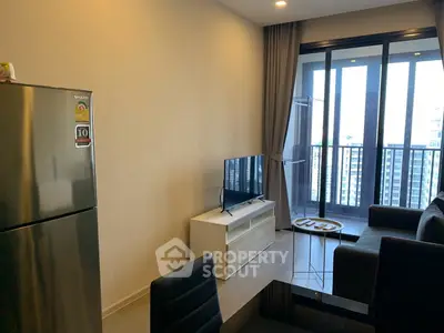 Modern living room with balcony view and sleek furniture in a high-rise apartment.