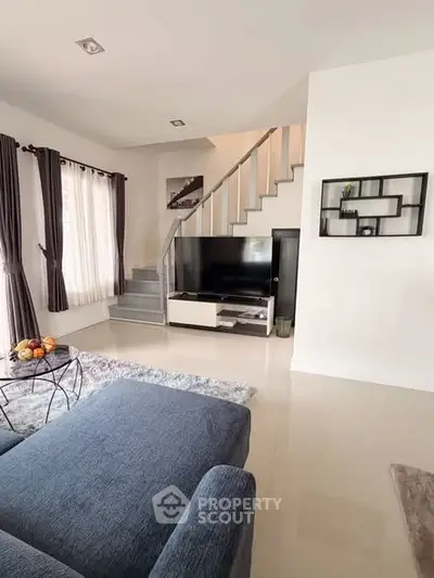 Modern living room with staircase and stylish decor