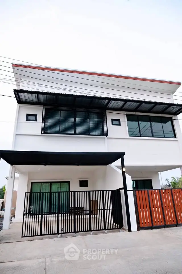 Modern two-story house with sleek design and gated entrance