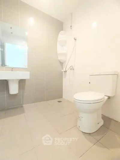 Spacious modern bathroom with sleek fixtures and neutral tiles