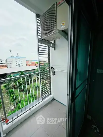 Charming balcony with air conditioning unit and scenic view of surrounding buildings and greenery.