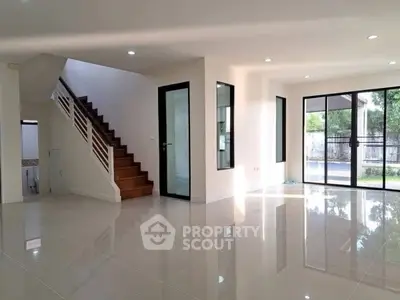 Spacious modern living room with glossy tile flooring and large windows for natural light.