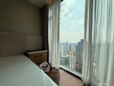Luxurious bedroom with stunning city view from floor-to-ceiling windows in high-rise apartment.