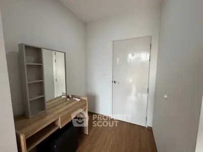 Modern minimalist bedroom corner with wooden floor and sleek vanity desk