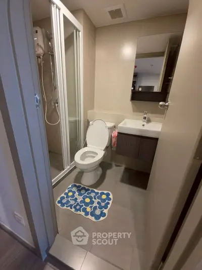 Modern bathroom with shower and stylish vanity in a contemporary apartment.