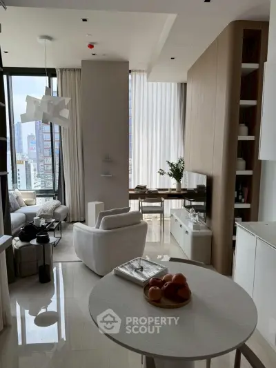Modern living room with elegant decor and city view, featuring stylish furniture and natural light.