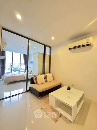 Modern studio apartment with glass partition and cozy living area