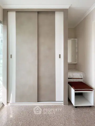 Modern bedroom with built-in wardrobe and stylish vanity area