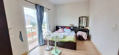 Cozy bedroom with balcony access and natural light in modern home