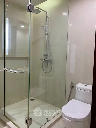 Modern bathroom with glass shower enclosure and sleek fixtures