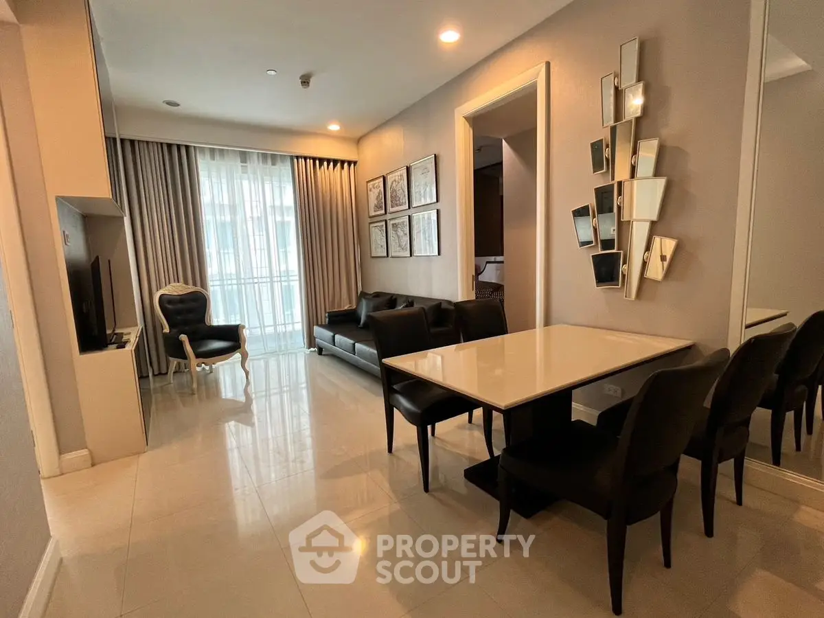 Modern living room with elegant dining area and stylish decor in a luxurious apartment.
