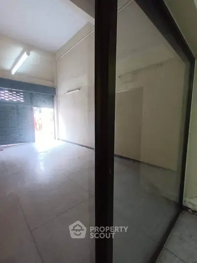 Spacious commercial space with large windows and high ceilings, ideal for retail or office use.