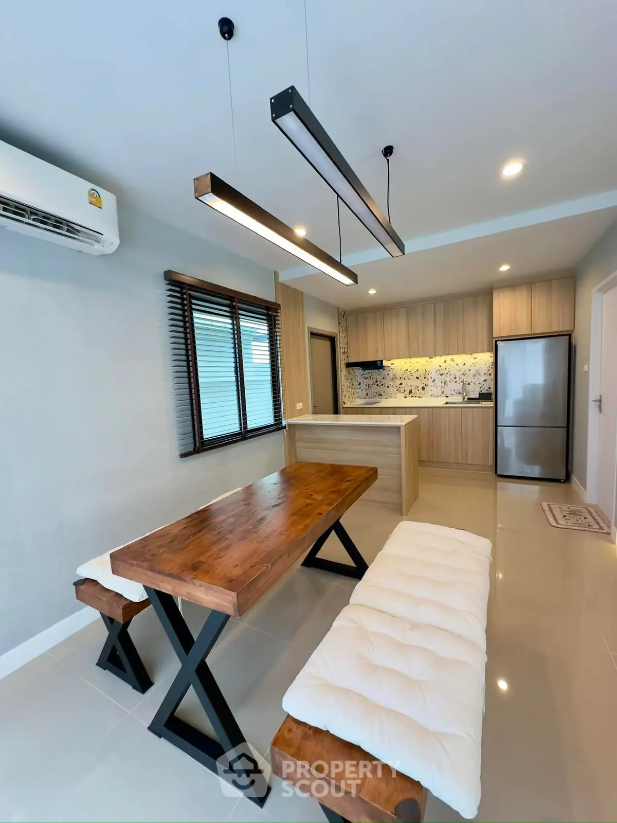 Modern kitchen with wooden dining table and sleek appliances