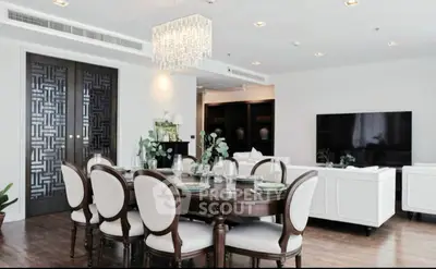 Elegant dining room with chandelier and stylish furniture in modern apartment.