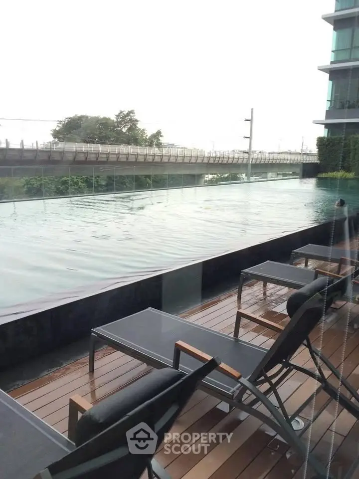 Luxurious poolside view with modern lounge chairs and serene ambiance.