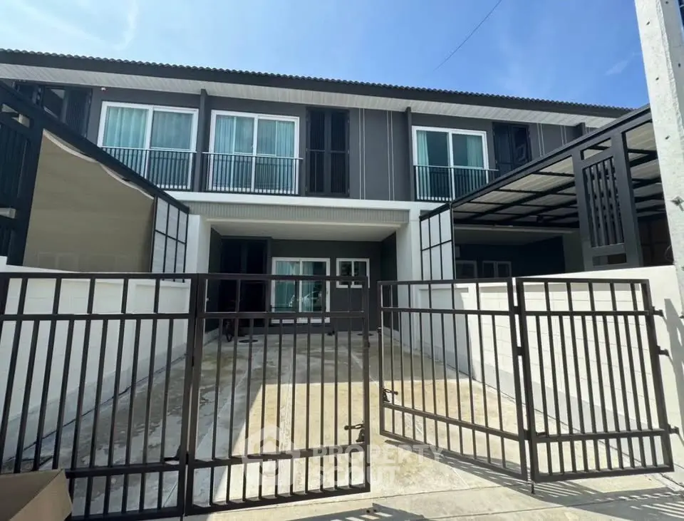 Modern townhouse exterior with gated entrance and sleek design