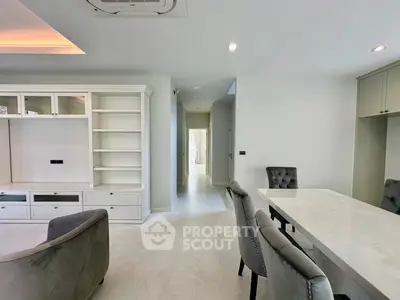 Elegant modern living space with built-in shelving and stylish dining area