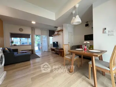 Spacious open-plan living and dining area with modern decor and natural light.