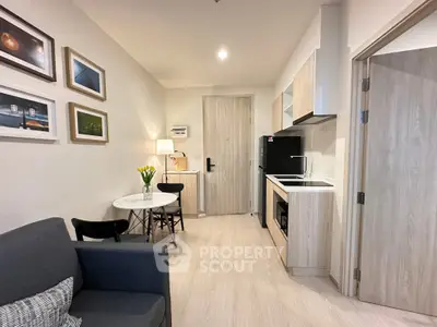 Modern studio apartment with cozy living area and compact kitchen