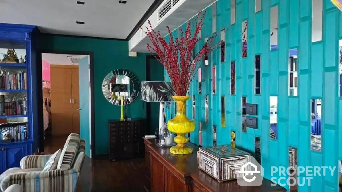 Vibrant living room with teal accent wall and eclectic decor