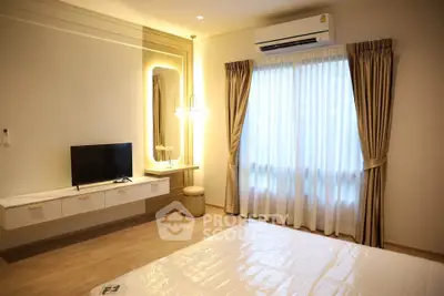 Elegant bedroom with modern decor, featuring a wall-mounted TV, air conditioning, and soft lighting.