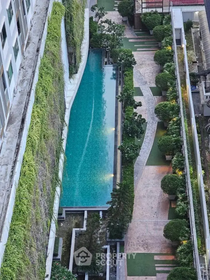 Luxurious apartment complex with stunning rooftop pool and lush greenery, perfect for urban living.