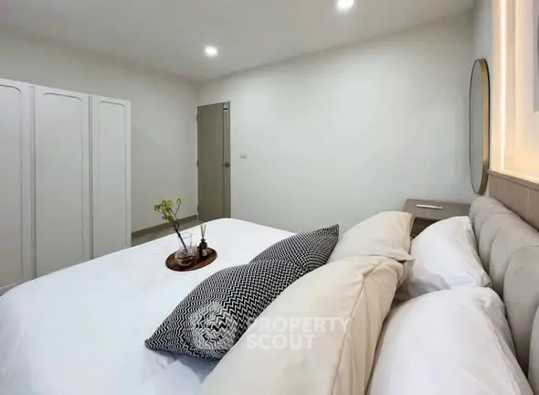 Spacious bedroom with modern decor and ample natural light