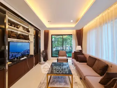 Luxurious living room with modern decor and large windows offering a serene garden view.