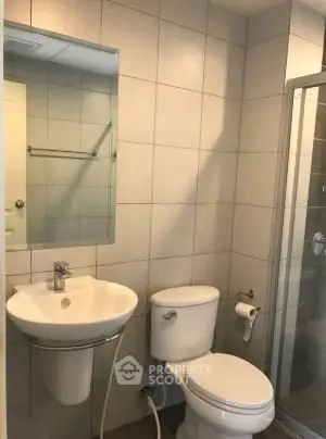 Modern bathroom with sleek fixtures and glass shower enclosure