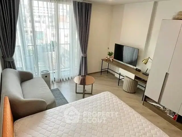 Modern studio apartment with cozy living area and natural light